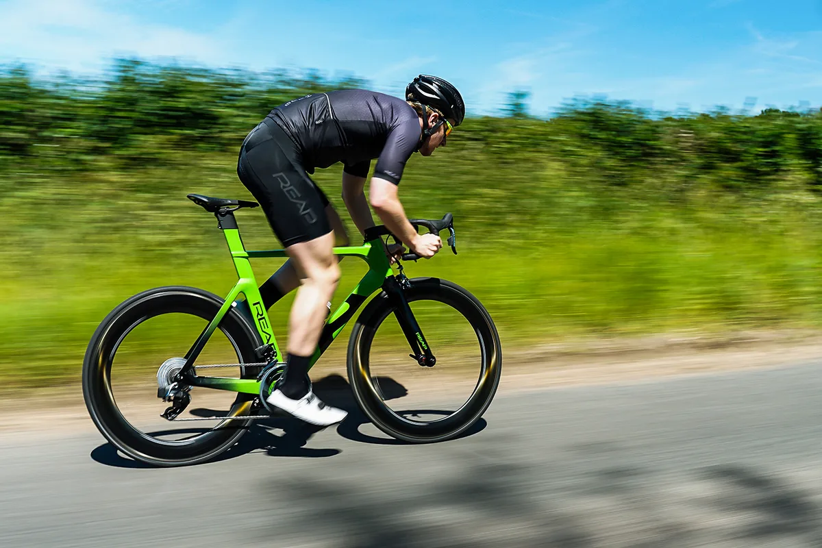 Rider sprinting on a Reap Vekta SRAM Red eTap AXS Hyper Green