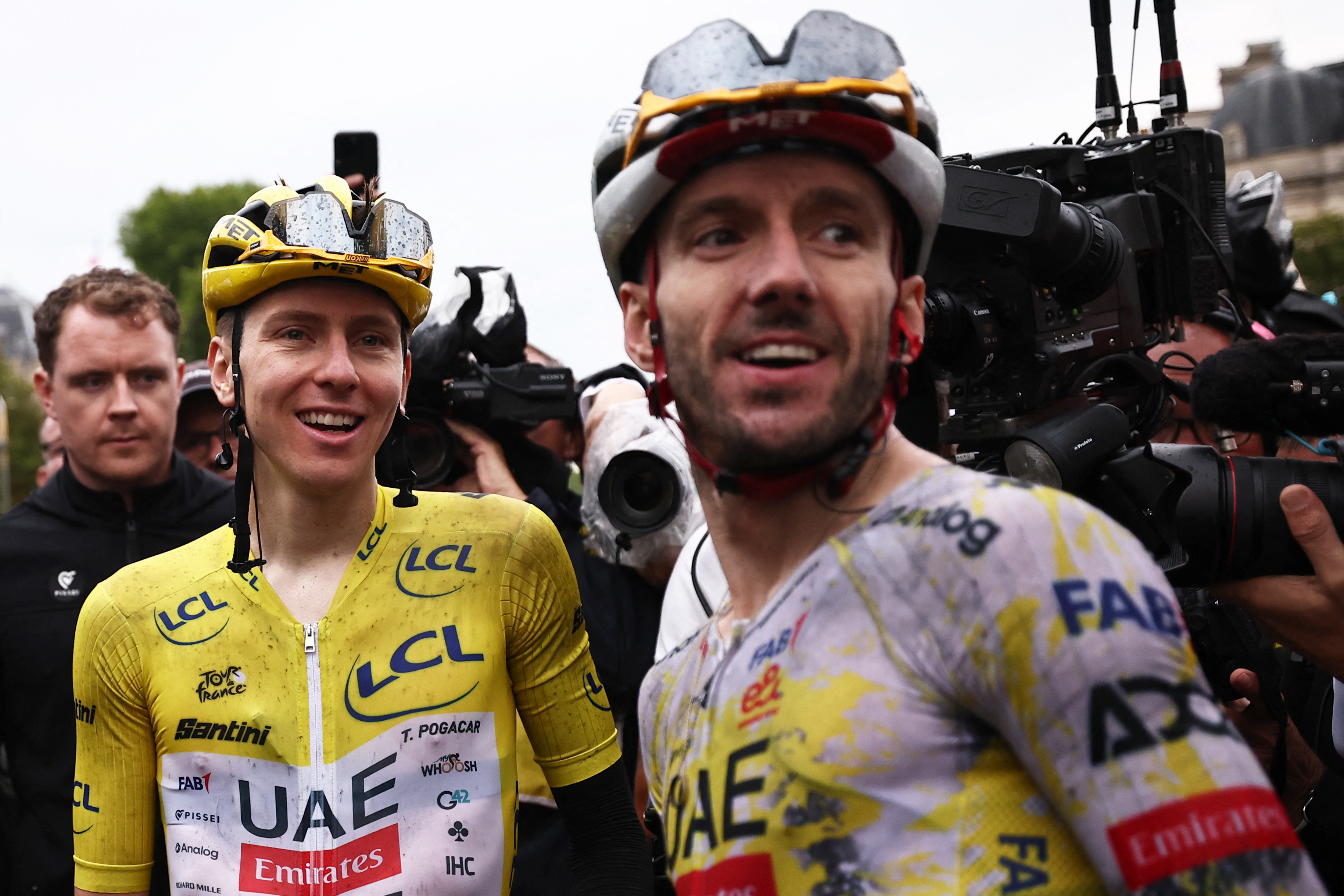 UAE Team Emirates - XRG team's Slovenian rider Tadej Pogacar celebrates his overall victory with UAE Team Emirates - XRG team's British rider Adam Yates after the 21st and final stage of the 112th edition of the Tour de France cycling race, 132.3 km between Mantes-la-Ville and Paris Champs-&Eacute;lysees, on July 27, 2025. (Photo by Anne-Christine POUJOULAT / AFP) (Photo by ANNE-CHRISTINE POUJOULAT/AFP via Getty Images)
