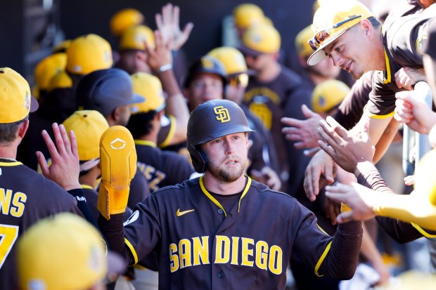 Jake Cronenworth #9 of the San Diego Padres is congratulated in the dugout after scoring a run against the Seattle Mariners during spring training game at the Peoria Sports Complex on Thursday, March 5, 2026 in Peoria, Ariz.(Meg McLaughlin / The San Diego Union-Tribune)