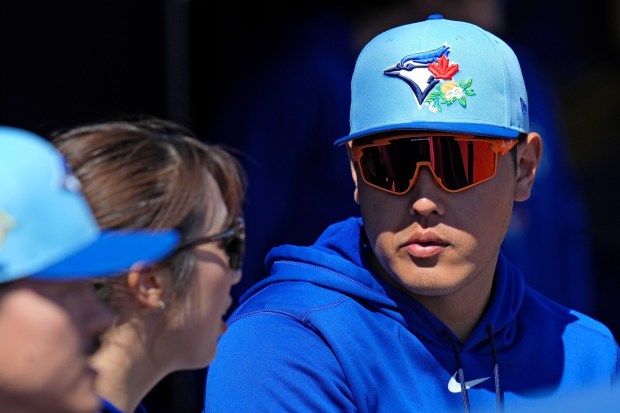 Toronto Blue Jays' Kazuma Okamoto, of Japan, watches from the dugout during the first inning of a spring training baseball game against the New York Yankees Tuesday, Feb. 24, 2026, in Dunedin, Fla. (AP Photo/Chris O'Meara)