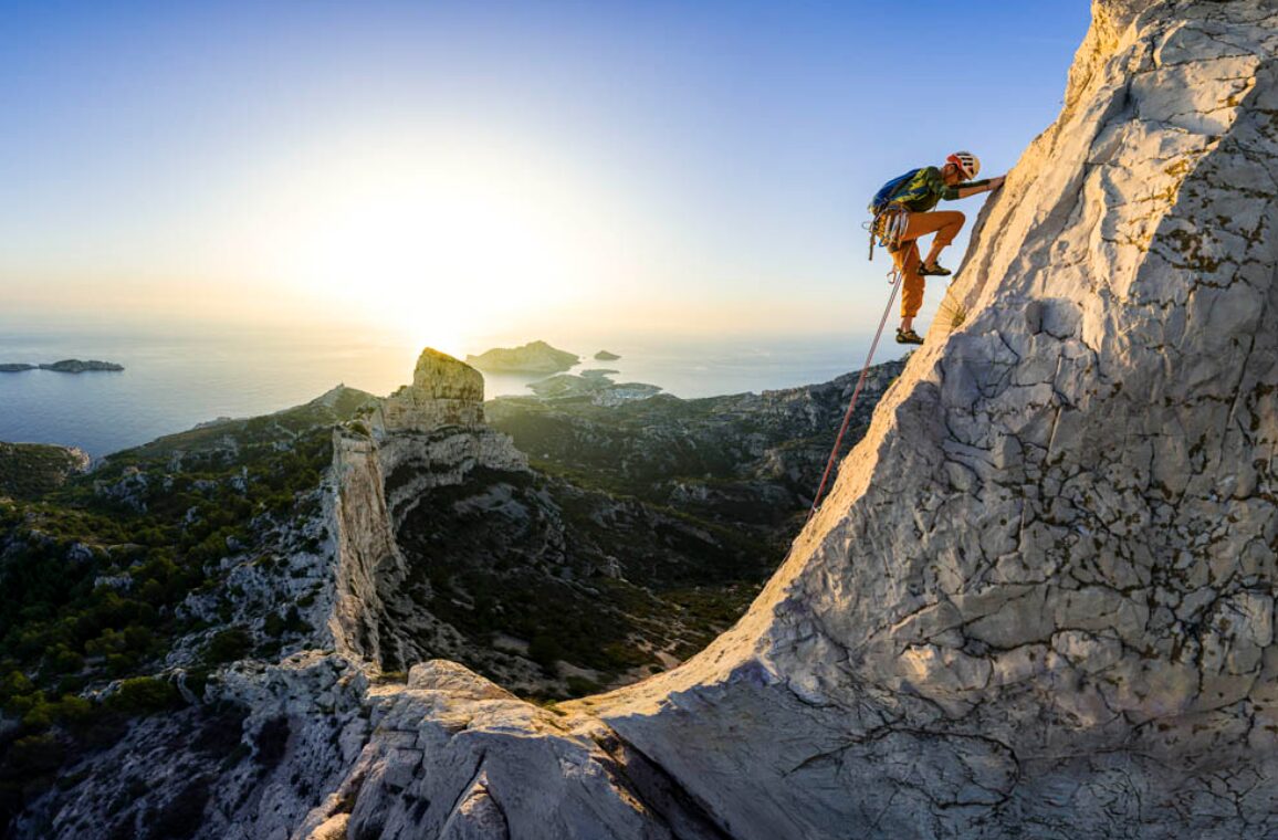 A solo climber making his way along a steep ridege