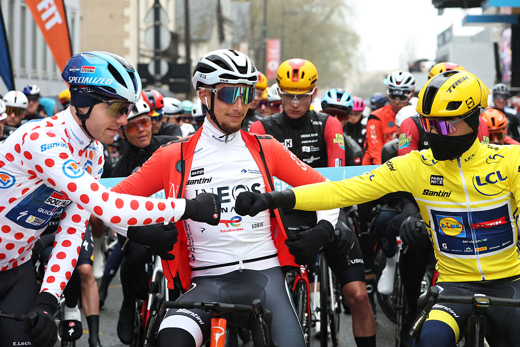 Soudal Quick-Step's Danish rider Casper Pedersen (L), wearing the white with red polka dots best climber's jersey, INEOS Grenadiers' French rider K&eacute;vin Vauquelin and Lidl - Trek's Spanish rider Juan Ayuso (R), wearing the overall leader yellow jersey, greet each other at the start of the 4th stage of the Paris-Nice cycling race, 195 km between Bourges and Uchon, on March 11, 2026. (Photo by Anne-Christine POUJOULAT / AFP)