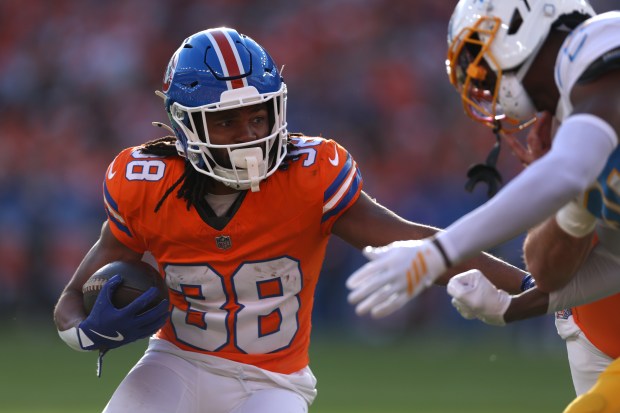 Jaleel McLaughlin of the Denver Broncos runs the ball in the first quarter against the Los Angeles Chargers at Empower Field At Mile High on Jan. 04, 2026 in Denver. (Photo by Matthew Stockman/Getty Images)