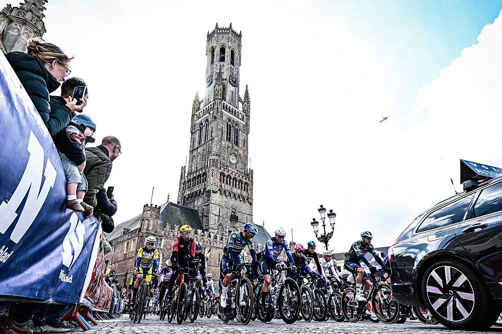 The pack rides in front of Belfry of Bruges during the 'Ronde van Brugge' men's elite one-day cycling race, 202,9 km from and to Bruges on March 25, 2026. (Photo by MAARTEN STRAETEMANS / Belga / AFP) / Belgium OUT
