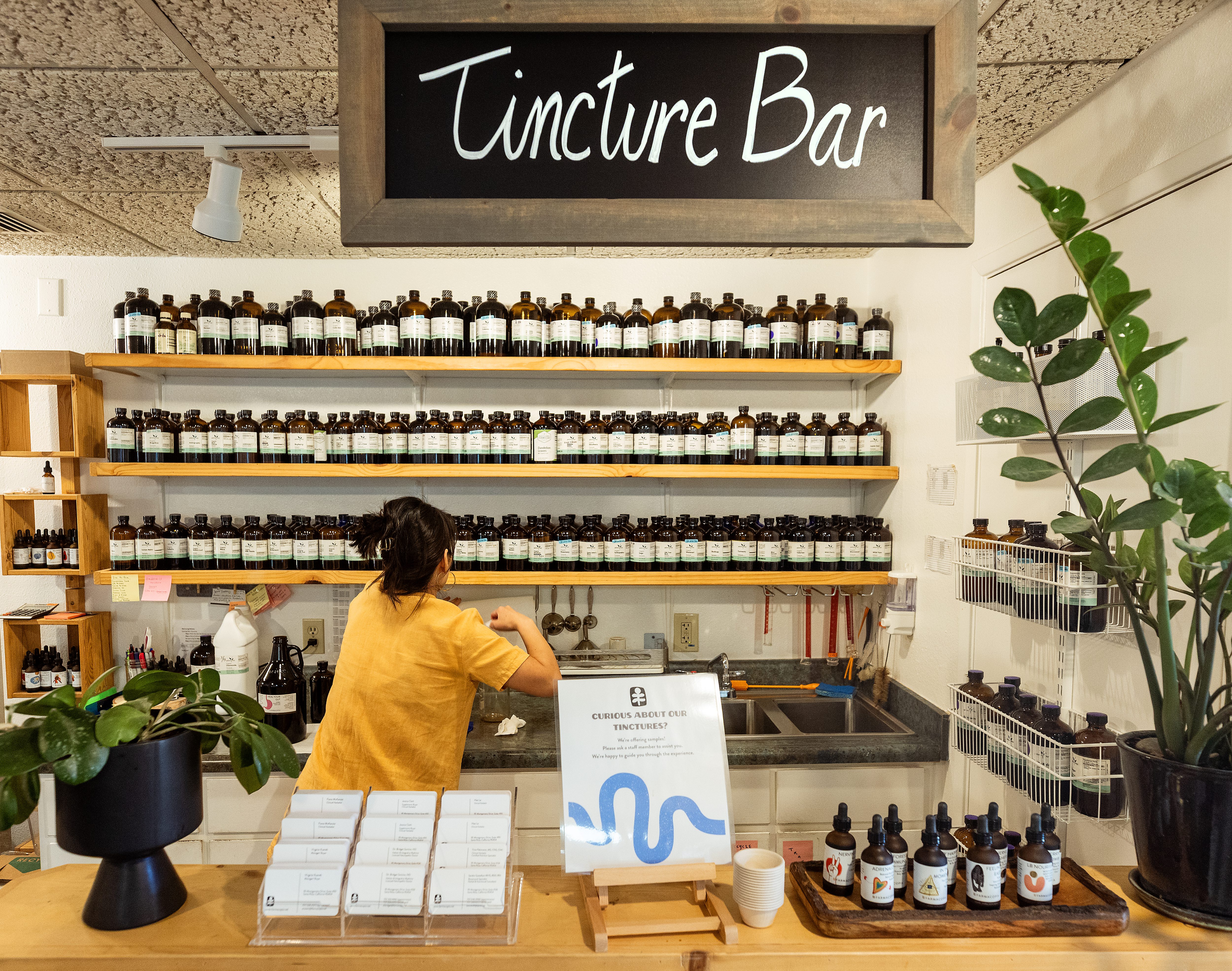 Clinical herbalist Hao Le mixes a recipe of herbal extracts...