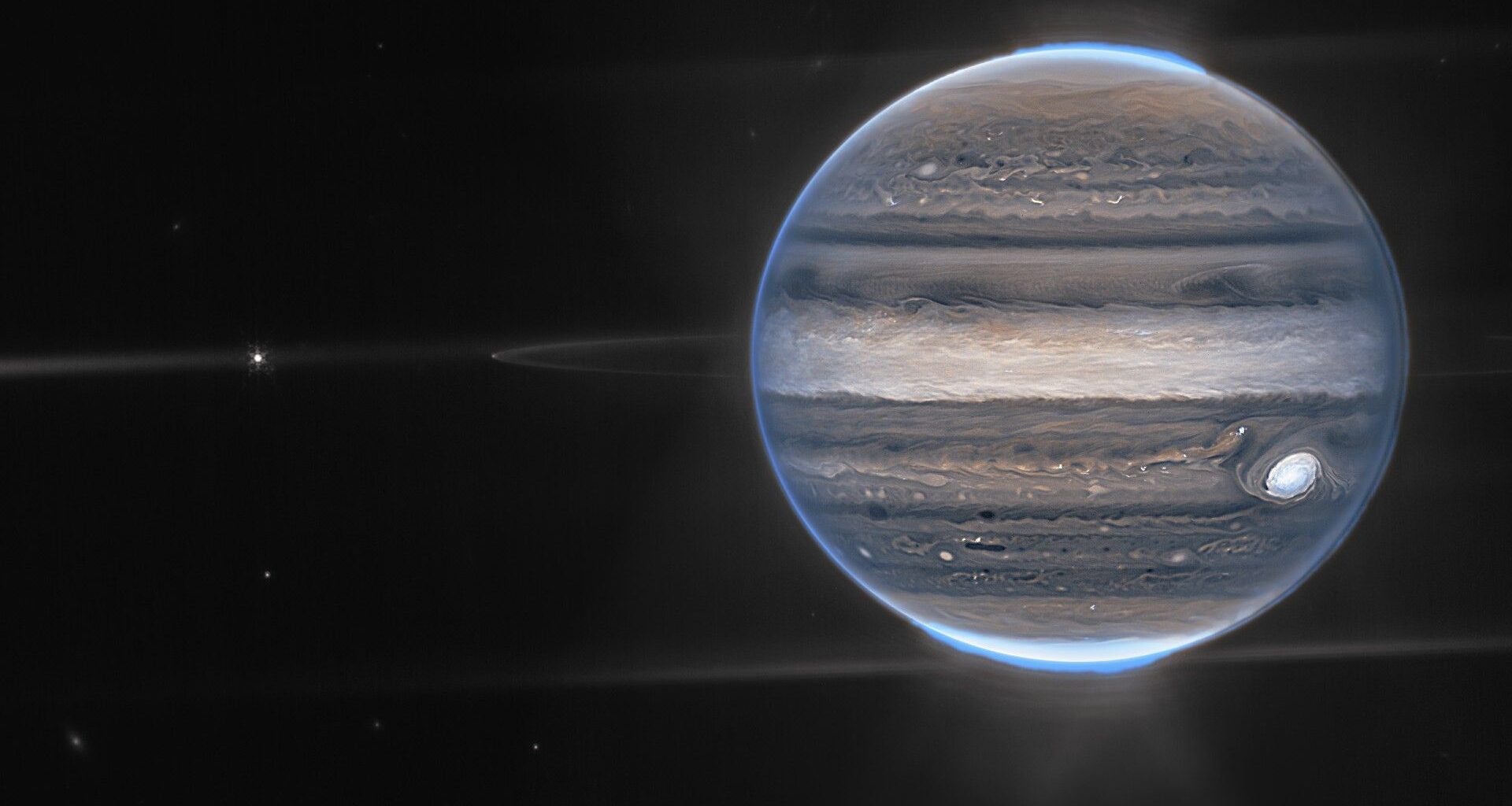 A marble-like planet in space, against the darkness of the cosmos, with a blue glowing light all around it.