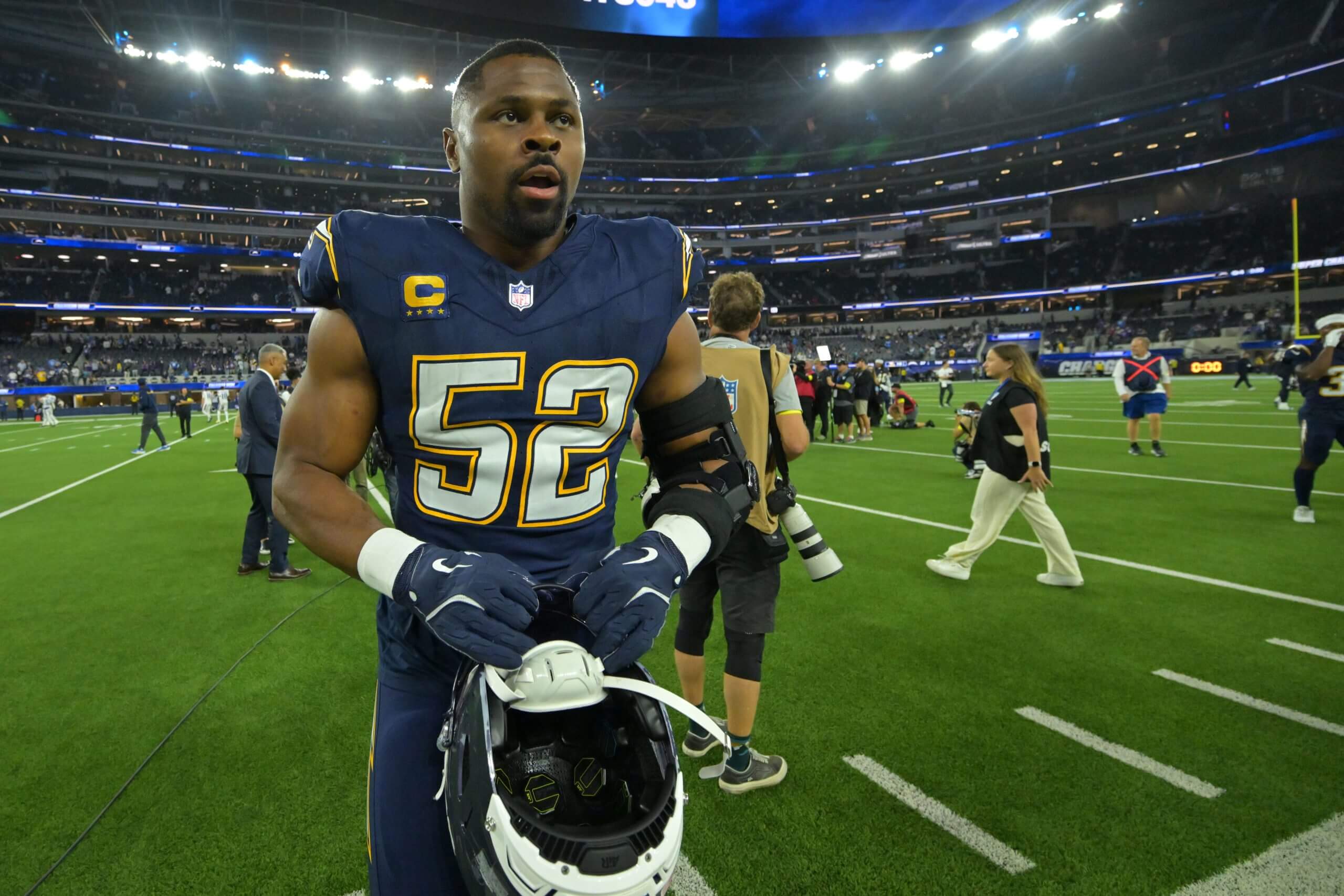 Los Angeles Chargers linebacker Khalil Mack (52) walks off the field with his helmet in his hand after a game at SoFi Stadium