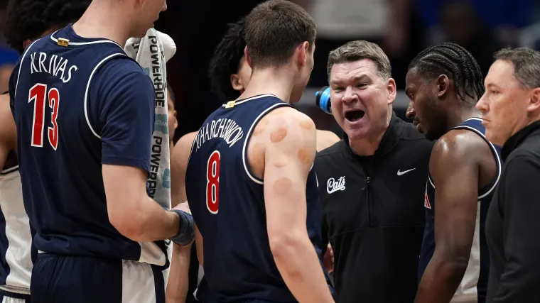 Arizona head coach Tommy Lloyd talks to players during the first half against the Kansas.
