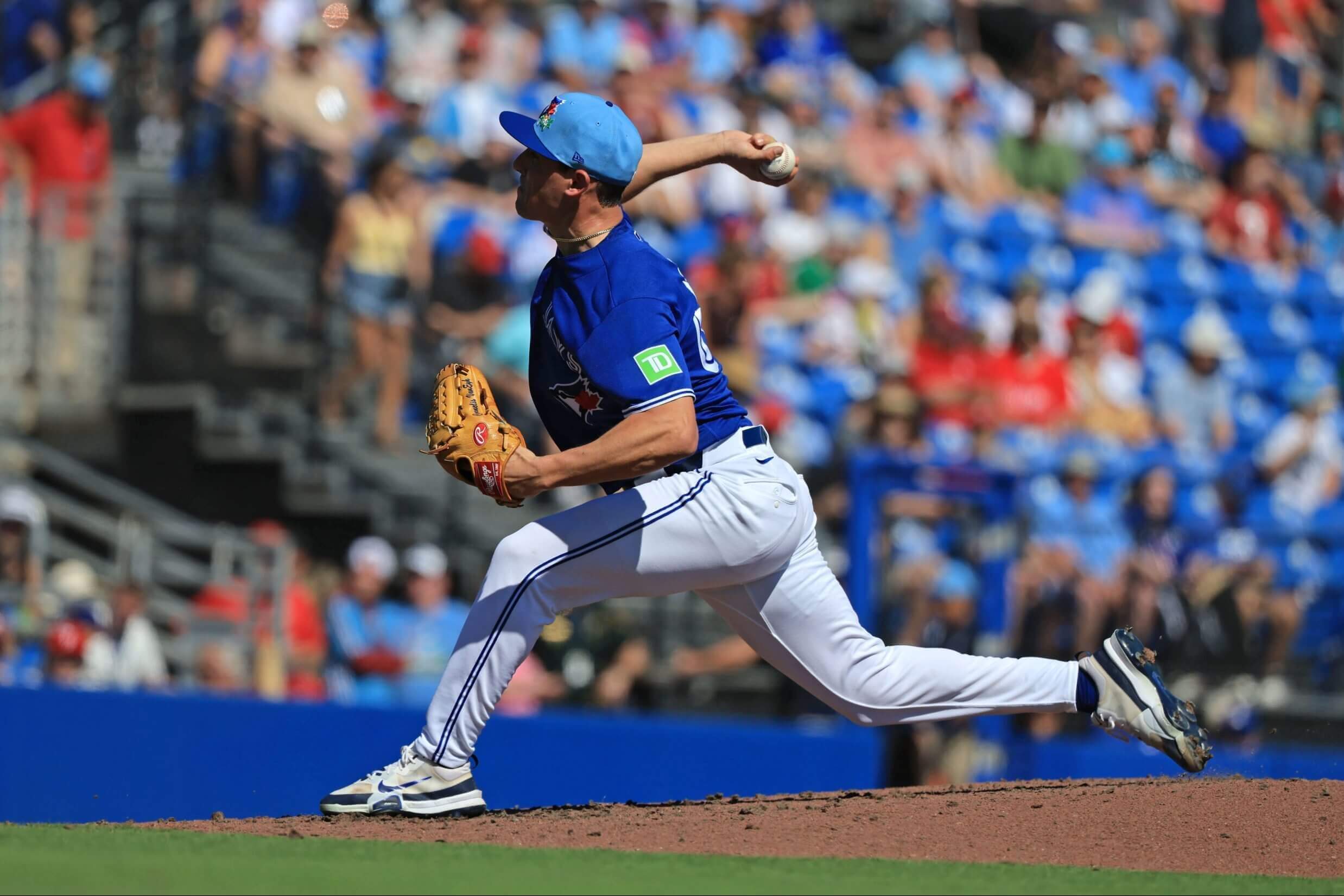 CJ Van Eyk, in a blue jersey top, delivers a pitch.