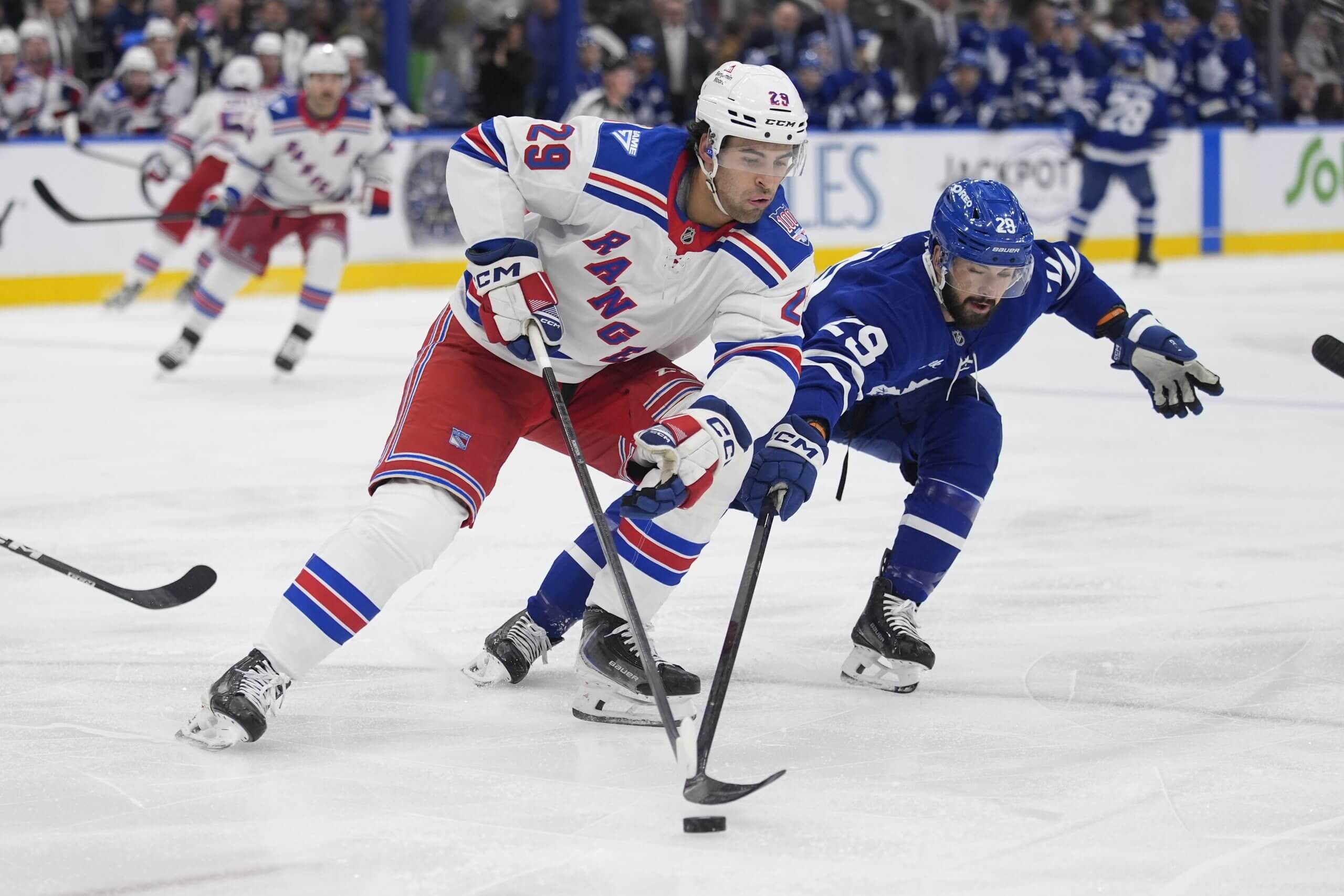 New York's Matthew Robertson and Toronto's Bo Groulx compete for possession of the puck.
