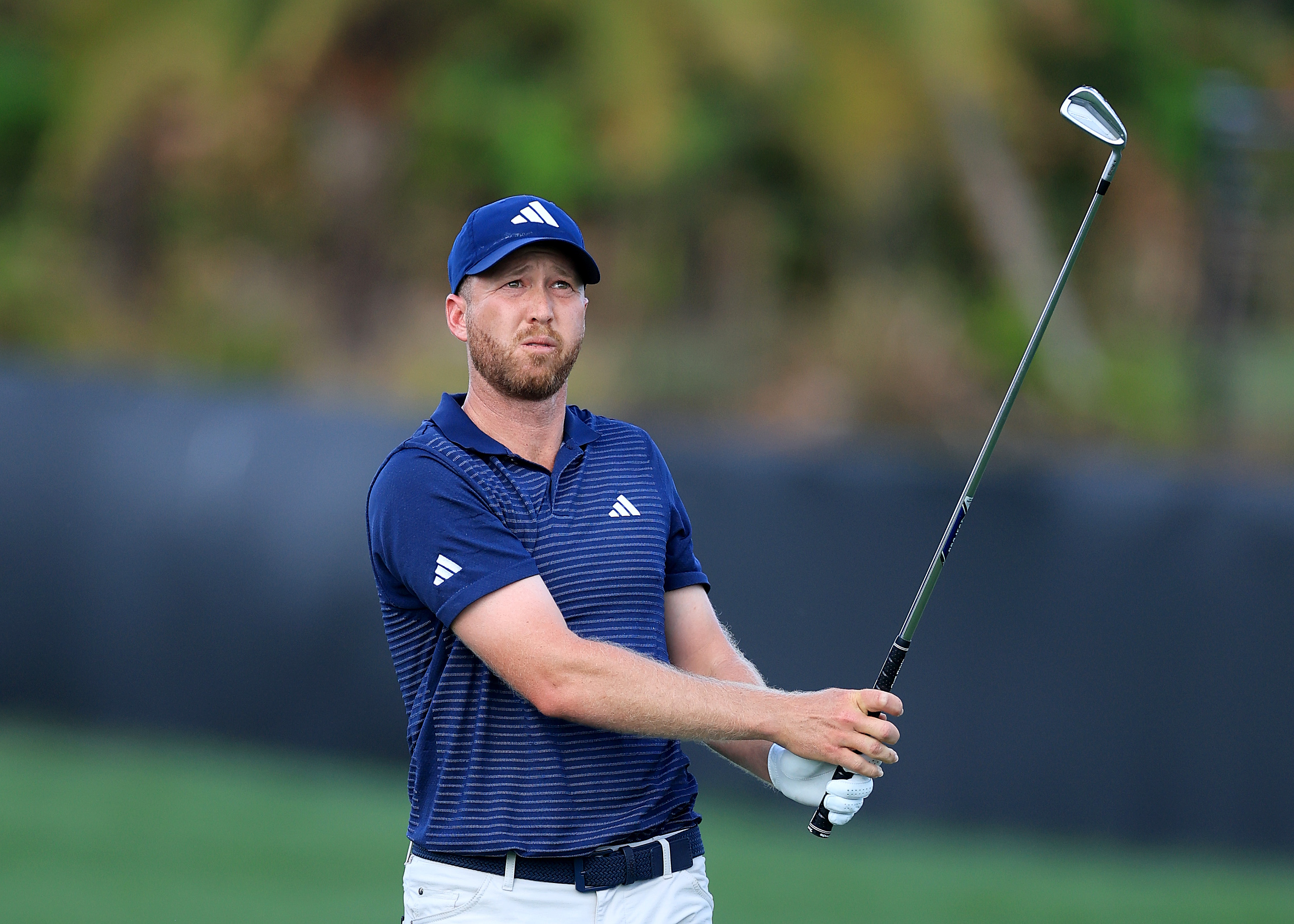 Daniel Berger hits an iron from the fairway