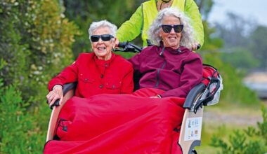 Joyce Grimer, 98, enjoys a Lakes Entrance esplanade ride with her daughter Pam Waters, piloted by volunteer Julie Chester, marking CWAG's oldest passenger to date. (PS)