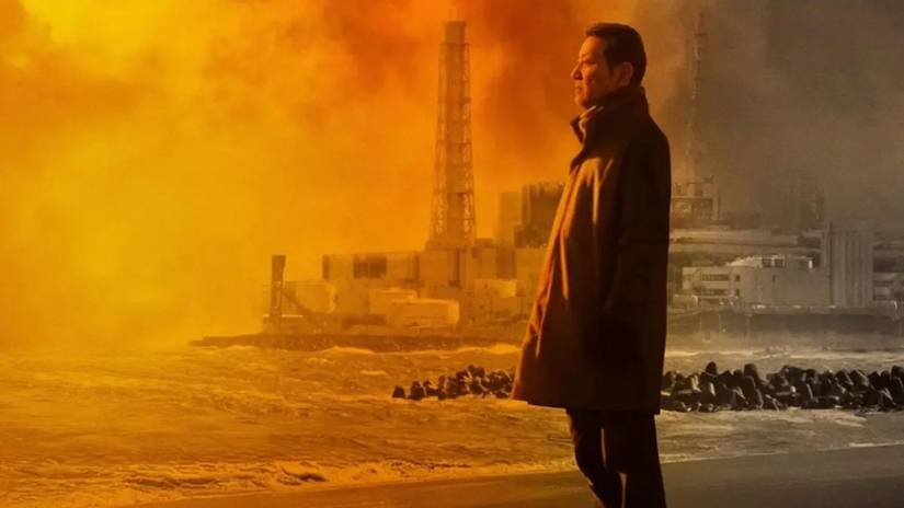 A man standing in front of a nuclear plant in Fukushima A Nuclear Nightmare