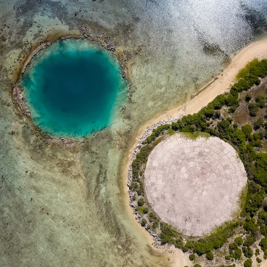 The dome and a water-filled crater left over by a nuclear bomb test.