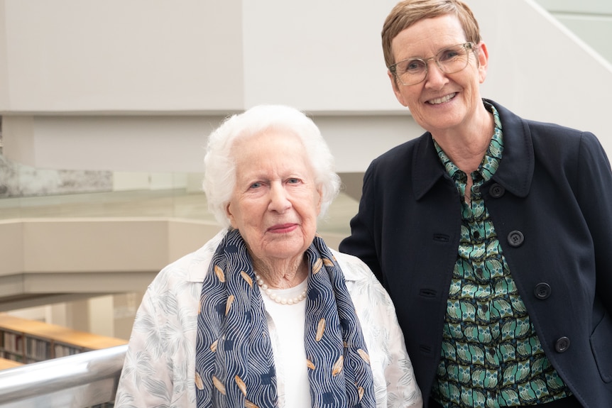Small woman with white hair next to woman with short brown hair and dark jacket