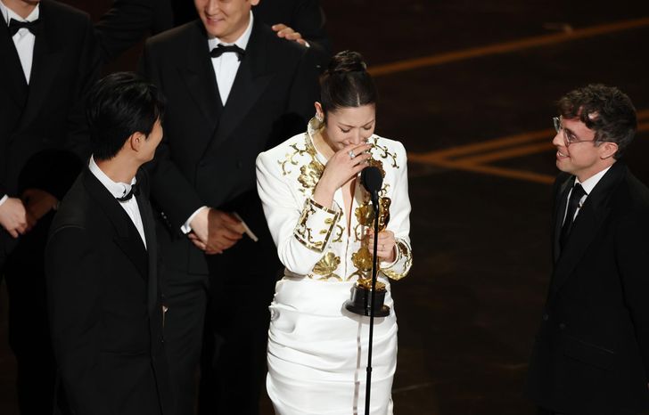 From left, Lee Yu-han,  EJAE, and Mark Sonnenblick react after winning the Oscar for Best Music (Original Song) for 'Golden' from 'KPop Demon Hunters'  during the 98th annual Academy Awards ceremony at the Dolby Theatre in Los Angeles, California, March 15. EPA-Yonhap 