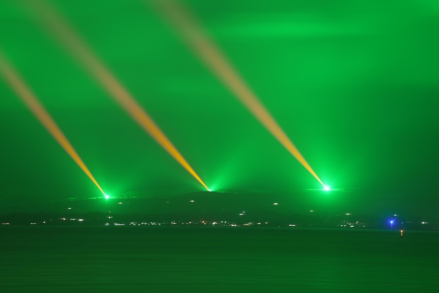 three light shining into the sky