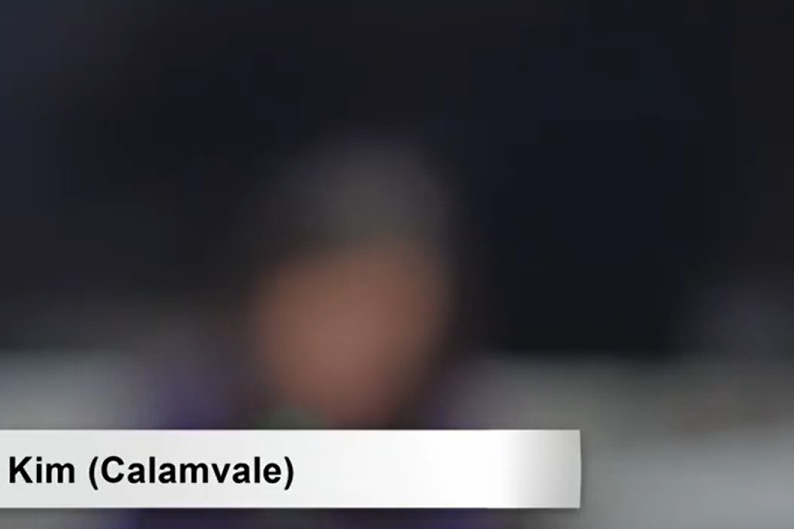 A blurry image of a woman in a meeting