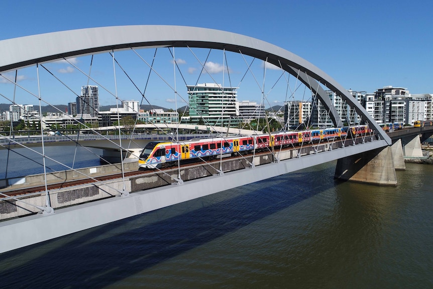 A train travelling along a city bridge.