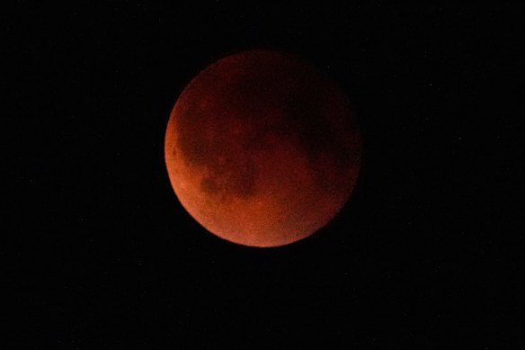 The moon appears red during a total lunar eclipse known as the blood moon seen from Rawalpindi, Pakistan, in September.