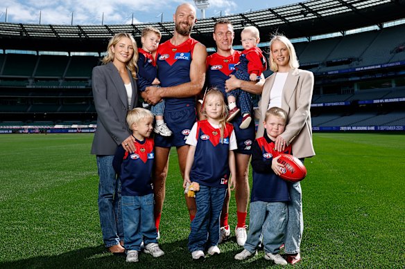 Max Gawn and wife Jess with children Louis and George. Tom McDonald and wife Ruby with children Hildie, Leo and Bella. Both players reach 250 games on Sunday. 