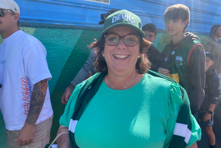 Football fans look at the camera.