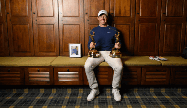 Rory McIlroy sits in the locker room at TPC Sawgrass with his two Players Championship trophies resting on his legs