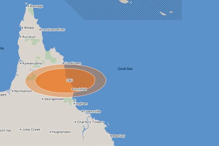 A blue and white map of Queensland with an orange oval shape indicating a tropical low.
