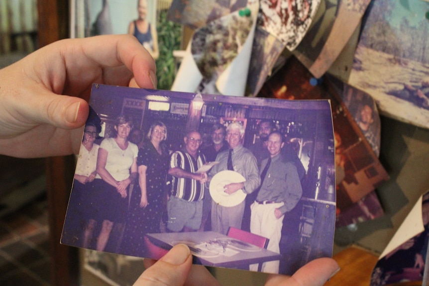 old photographs on the wall of an old pub, they're deteriorating.