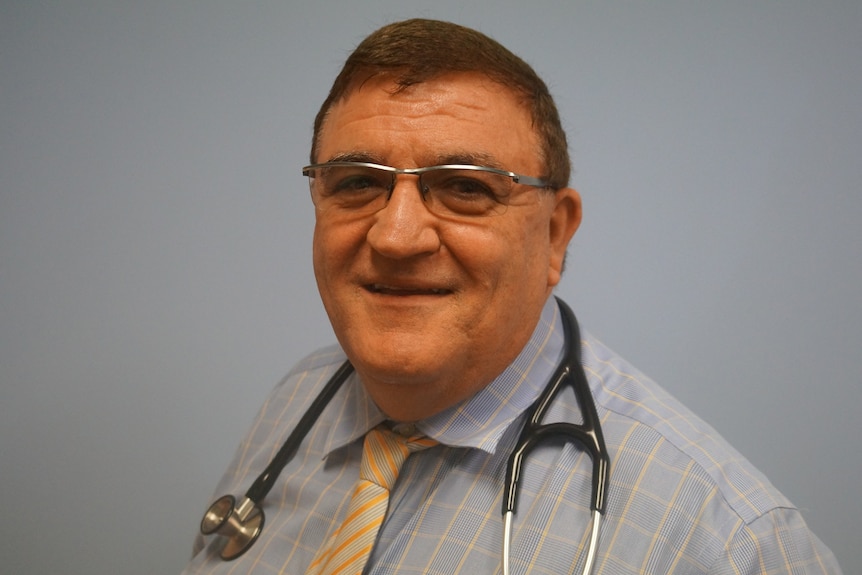 A man with a stethoscope around his neck.