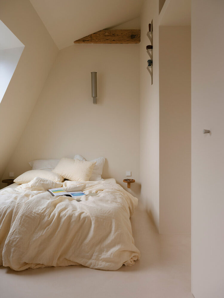 the bedroom nestles beneath the attic slope