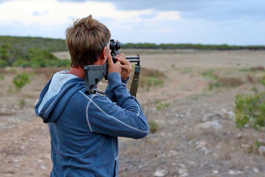 A man shoots a rifle