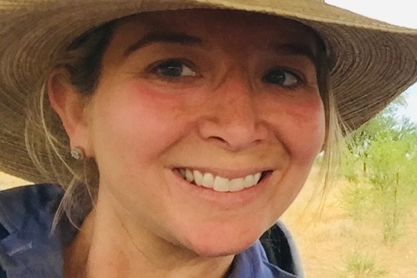 A woman wearing a broad brimmed country style hat 