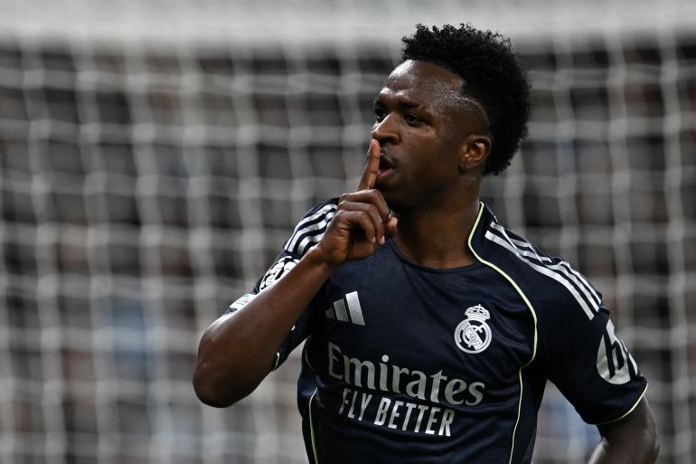 Real Madrid's Brazilian forward #07 Vinicius Junior celebrates scoring the opening goal during the UEFA Champions League, round of 16 second leg football match between Manchester City and Real Madrid at the Etihad Stadium in Manchester, north west England, on March 17, 2026. (Photo by Paul ELLIS / AFP)
