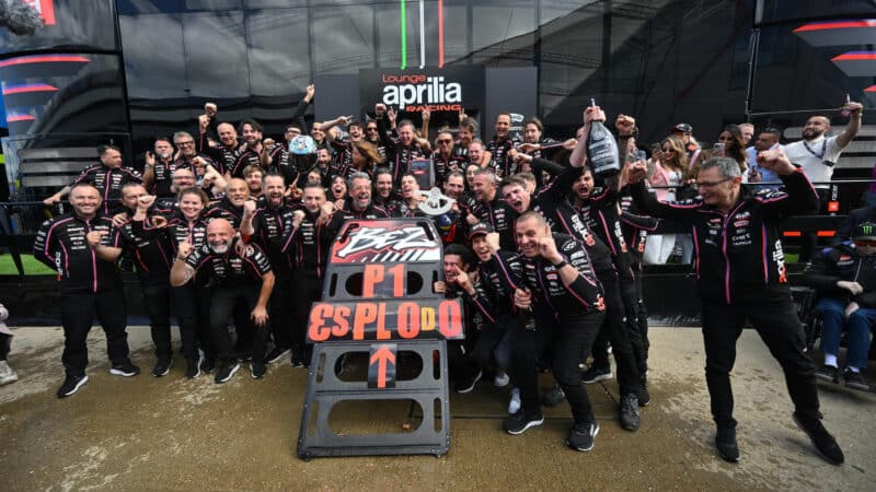 Aprilia celebrating Marco Bezzecchi’s 2025 British GP win, his first for the Noale brand. Bonora is far left
