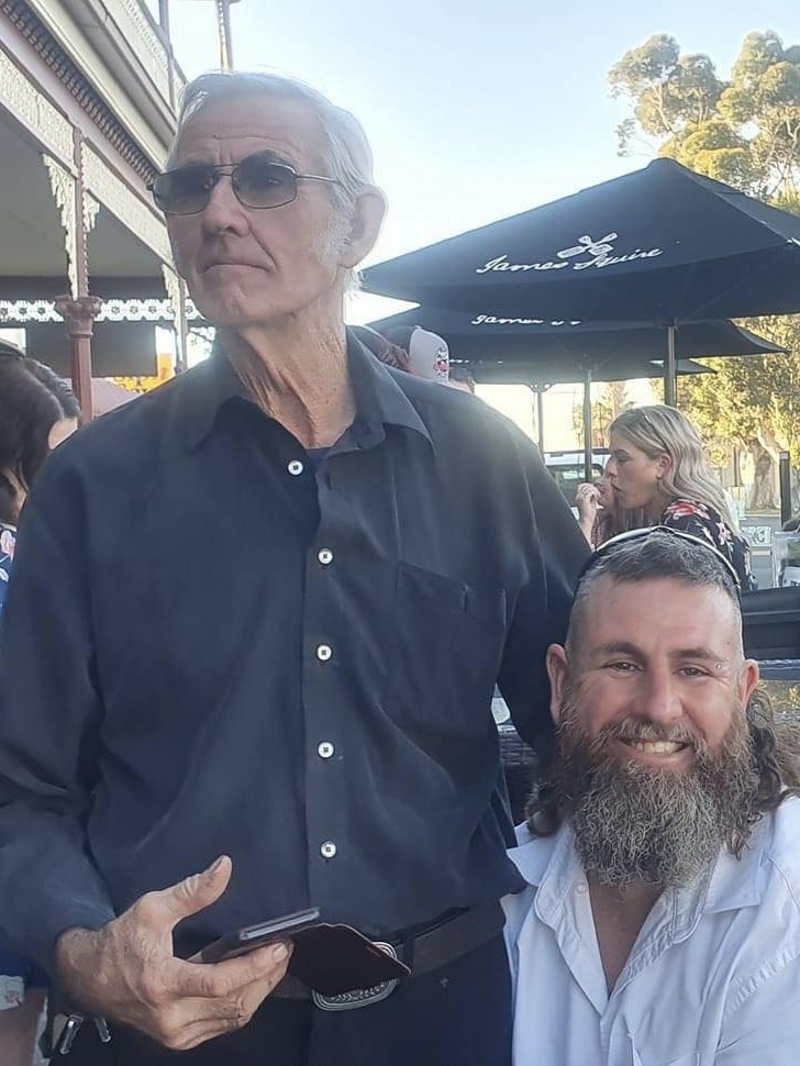 Two men side by side smiling.