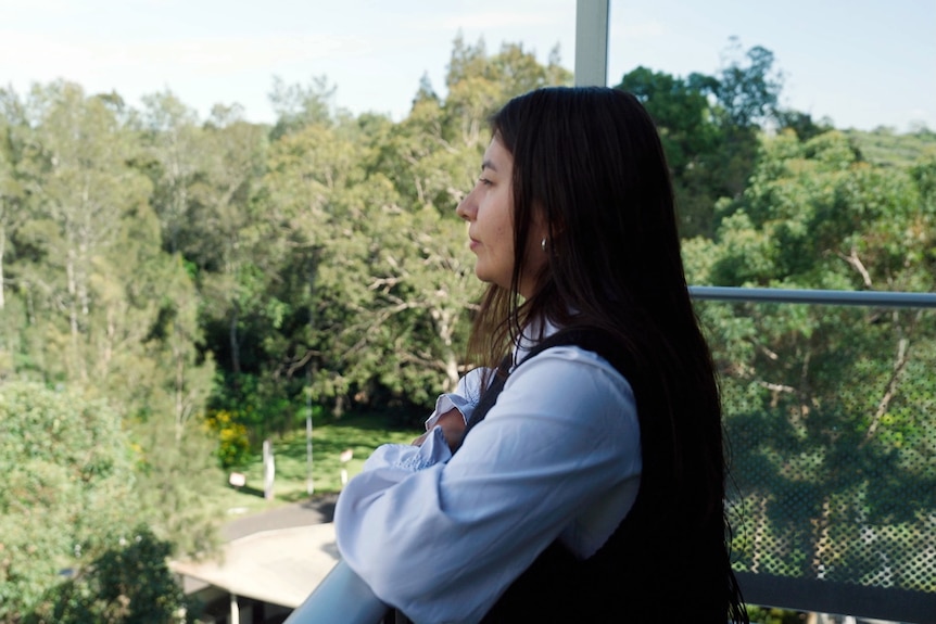 viviana who is a colobian national living in sydney looks put over a balcony