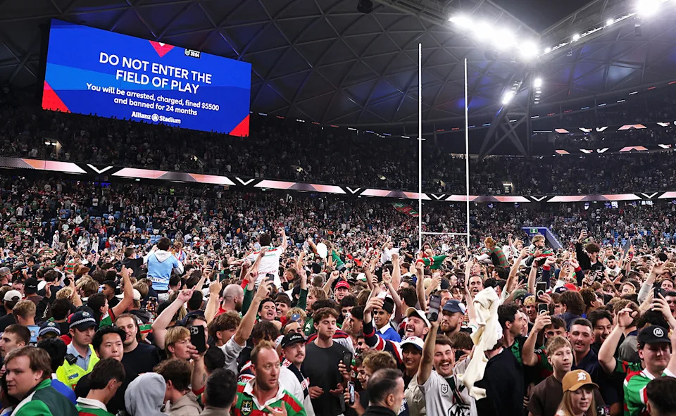 Spectators on the the pitch despite warnings.