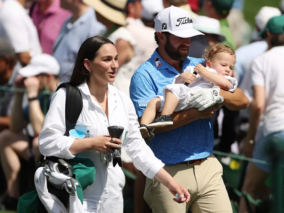 Cameron Young of the United States looks on with his wife Kelsey, and son Henry during the Par 3 contest prior to the 2023 Masters Tournament in Georgia.Credit: Patrick Smith/Getty