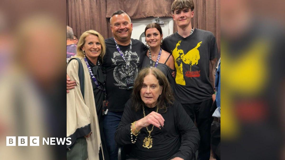 Pictured is Louis Osbourne with his wife, two children and Ozzy sat down in front of them while they gather around him smiling