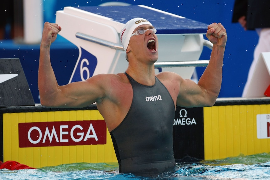 Swimmer César Cielo celebrates while wearing a torso-hugging swim suit.