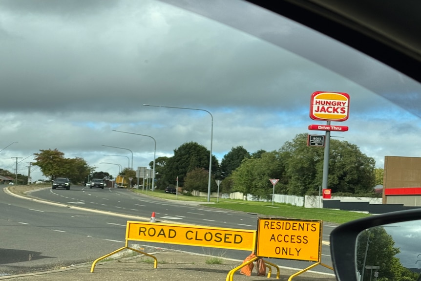 road closed sign on highway, in front of Hungry Jacks 