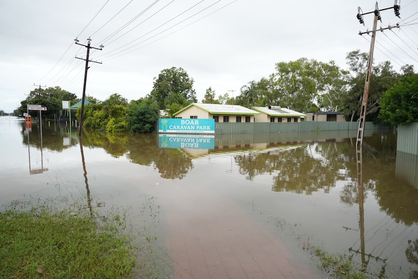 Flooding surrounds a regional caravan park.