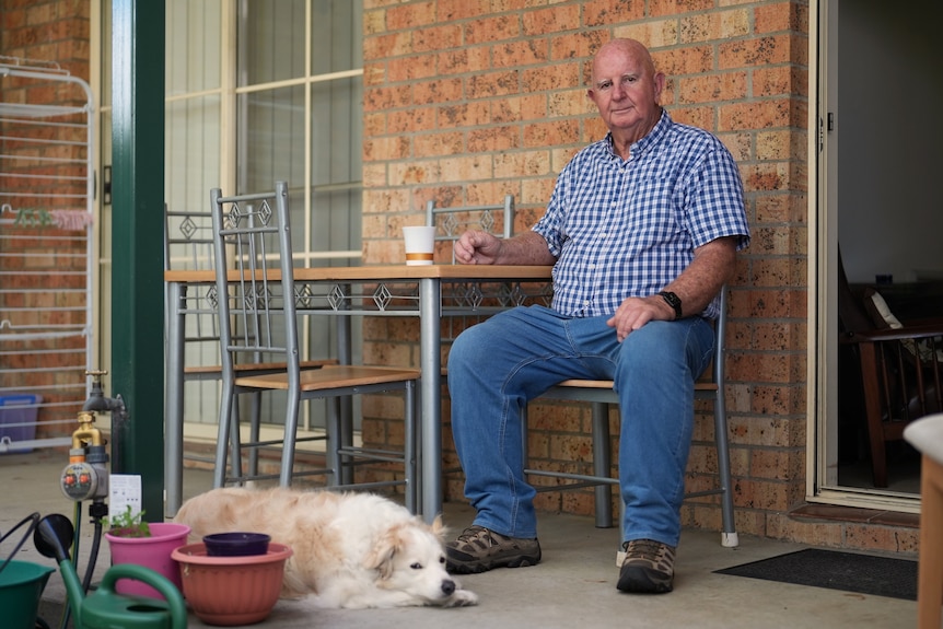 A man outside with his dog.