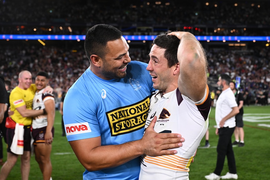 Ben Te'o and Ben Hunt smiles and embrace on the field after the Broncos won the grand final