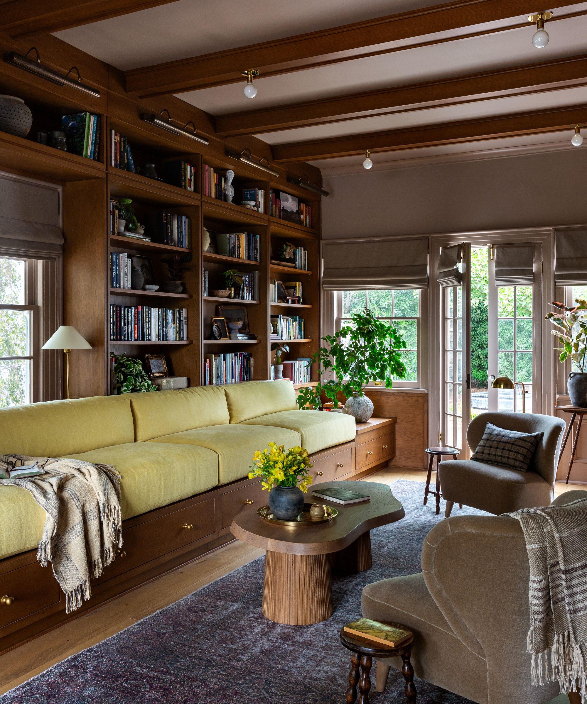 Library and games room with custom millwork and deep bench seating by Plaster &amp; Patina, Photograph Amy Bartlam