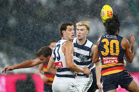 Shannon Neale of the Cats and Wayne Milera of the Crows compete for the ball.