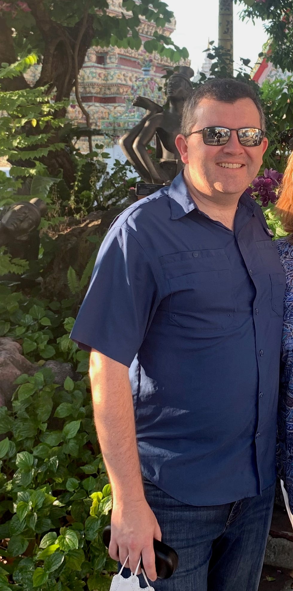 tony alvarado smiling outside in a green background