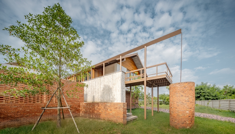 brick and concrete sculpt elevated riverfront residence in thailand by bodinchapa architects - 1