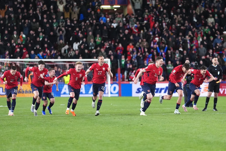 Czechia players run and celebrate after scoring the winning penalty in the shootout.
